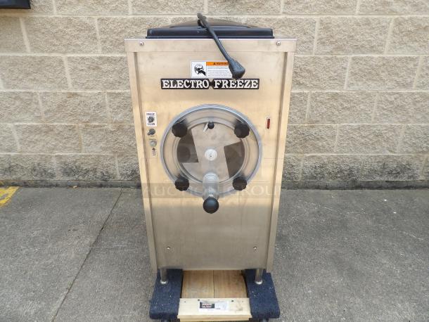 Electro Freeze soft serve machine, stainless steel, used condition. Features control panel with freeze and clean options.