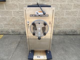 Electro Freeze soft serve machine, stainless steel, used condition. Features control panel with freeze and clean options.
