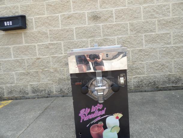 Slush machine with stainless steel top, labeled "Sip Into Paradise!" Showing fruit drinks. Used condition with visible scratches.
