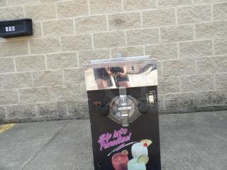 Slush machine with stainless steel top, labeled "Sip Into Paradise!" Showing fruit drinks. Used condition with visible scratches.