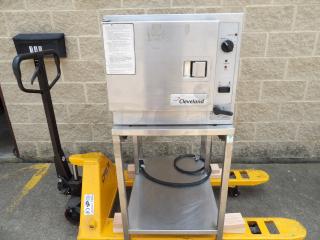 Cleveland steam oven on metal stand, power and reset dials, label shows operating instructions, sturdy condition.