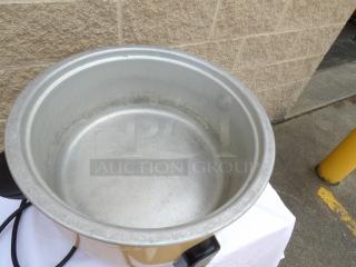 Large metal pot with electric heating base and cord, used condition. Scratches and discoloration visible inside and out.