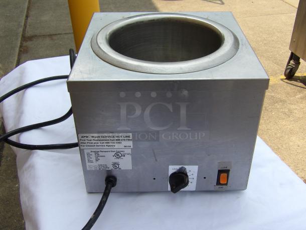 Stainless steel APW Wyott soup warmer in good condition. Features dial controls, power switch, and service label with contact info.