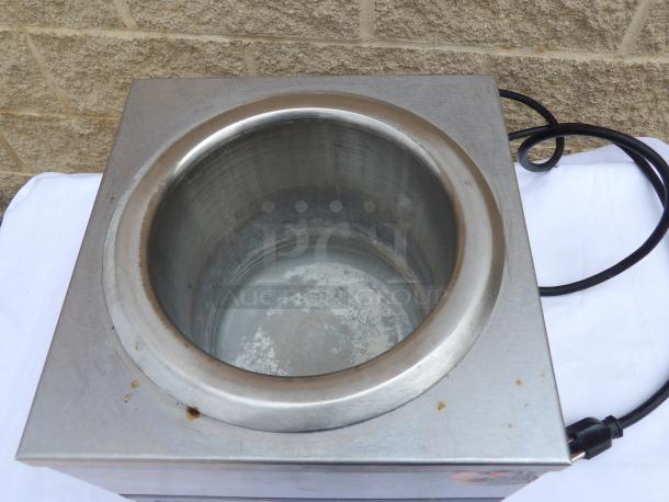 Stainless steel electric soup warmer with power cord, showing signs of wear. Ideal for food service use.
