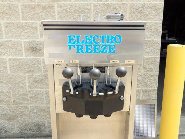 Electro Freeze ice cream machine, stainless steel, dual levers, used condition, labels indicate day-night settings.