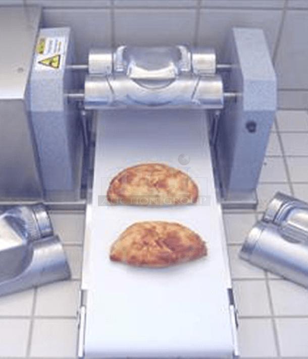 Commercial dough sheeter with conveyor belt in stainless steel, used condition, includes safety labels and adjustment controls.