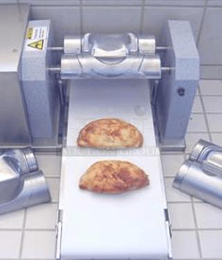 Commercial dough sheeter with conveyor belt in stainless steel, used condition, includes safety labels and adjustment controls.