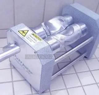Industrial rotary lobe pump with metal casing, visible warning label, and dual pipe system, in excellent condition.