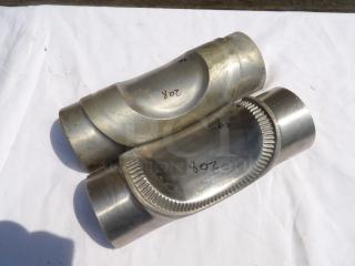 Two stainless steel exhaust pipe connectors, marked "208" and "#2." Showcasing smooth finish and welded seams.