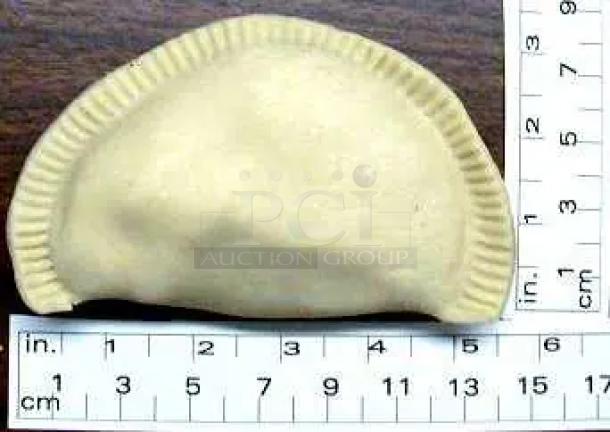 Ruler next to a beige, baked clay dumpling figurine with textured edges, approximately 7 cm wide.