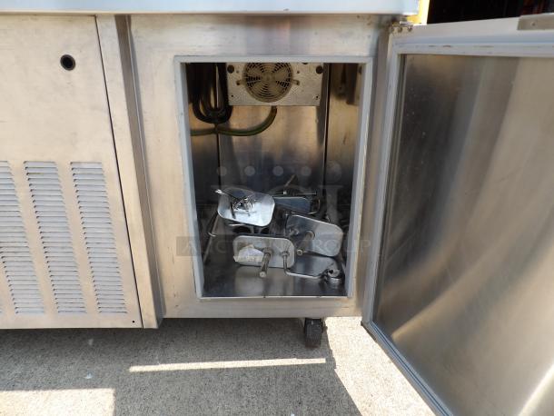 Commercial stainless steel refrigeration unit with open compartment showing interior fan and metal trays. Clean, used condition.