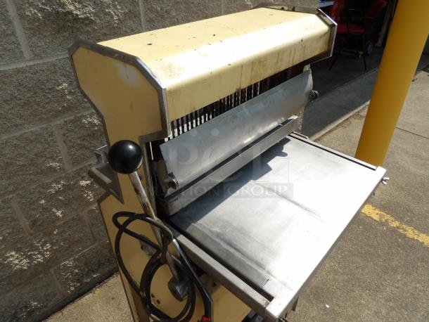 Industrial dough divider with stainless steel tray, manual lever, in fair condition, shows signs of use.
