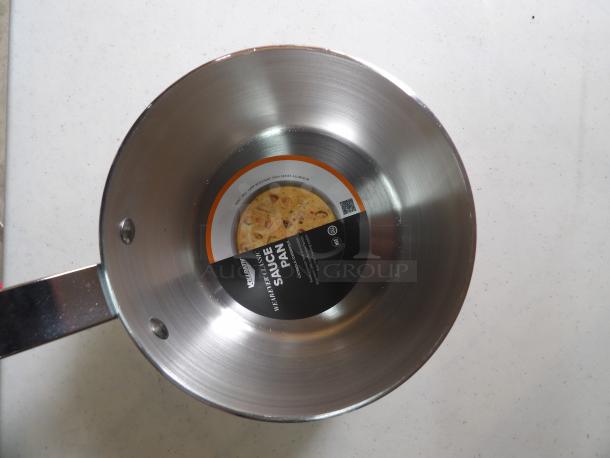 Stainless steel saucepan with label indicating "WearEver Classic Sauce Pan." New condition, durable handle, 2004-series aluminum.