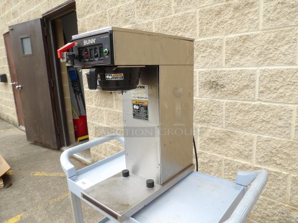 Bunn commercial coffee brewer, stainless steel, model CW Series, with control switches and caution labels, in good condition.