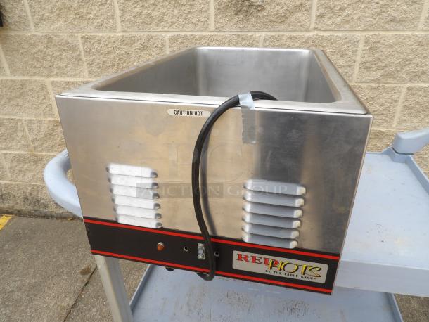 Stainless steel food warmer by The Eagle Group, RE*:PORT model; features "Caution Hot" label; electrical cord attached.