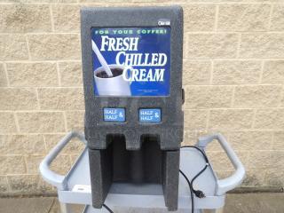Chilled cream dispenser labeled "Fresh Chilled Cream," with slots for "Half & Half." Used condition, on a cart with power cord.