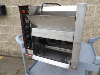 Commercial conveyor toaster by APW Wyott, stainless steel, adjustable heat controls, used, on cart.