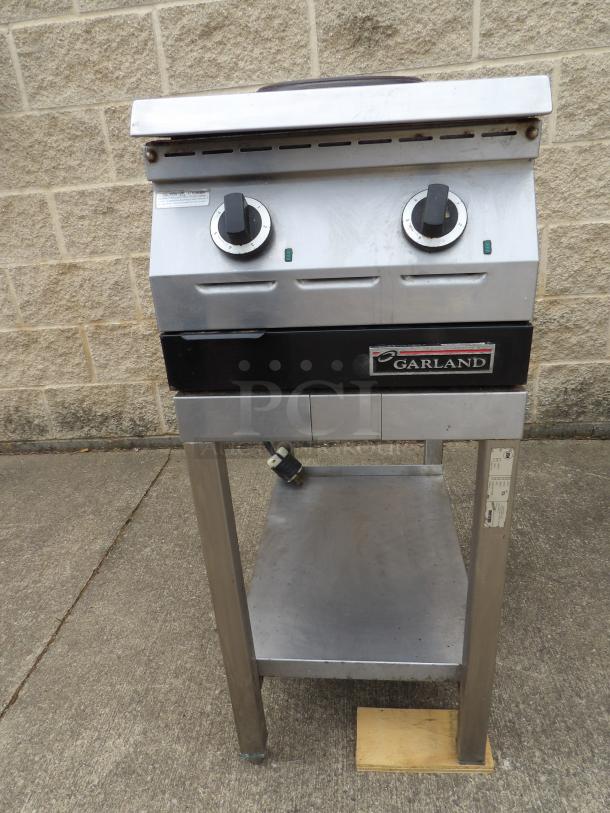 Garland electric griddle with dual controls, stainless steel, fair condition. Manufacturer's label visible on front.