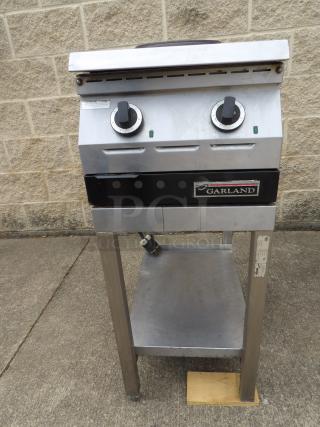 Garland electric griddle with dual controls, stainless steel, fair condition. Manufacturer's label visible on front.