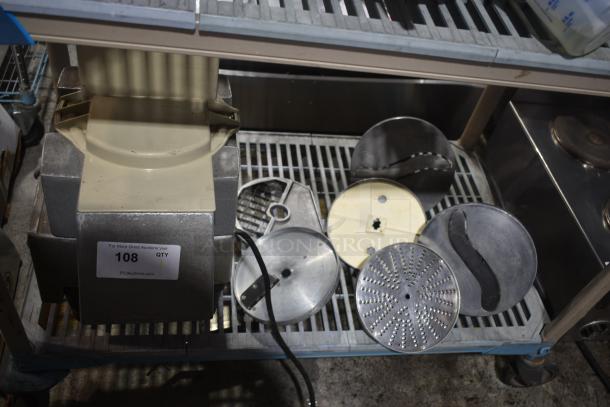 Industrial slicer with multiple stainless steel discs on a shelf. Label reads "PCI Auctions" and item number 108. Slight wear.