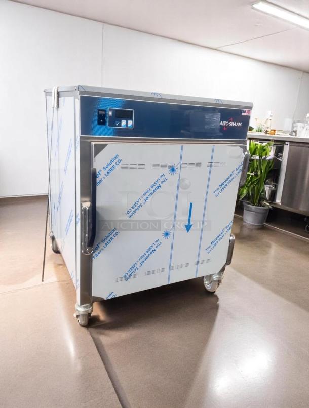 Alto-Shaam commercial oven, new condition, stainless steel, protective film intact, digital control panel, on casters for mobility.