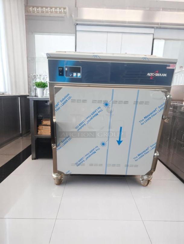 Alto-Shaam commercial oven, stainless steel, new condition, protective film intact, digital controls, on casters.