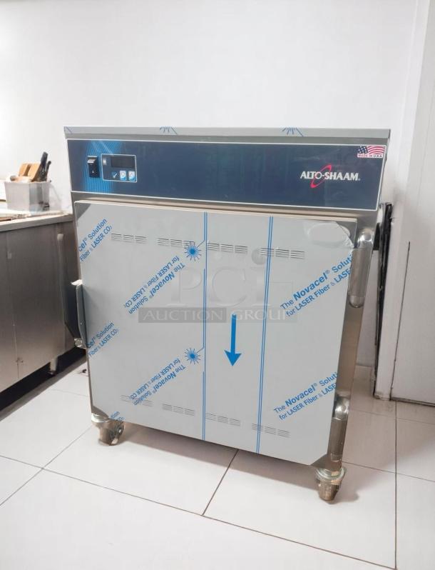 Alto-Shaam warming cabinet, new condition, protective film intact, stainless steel, USA-made label on top right.