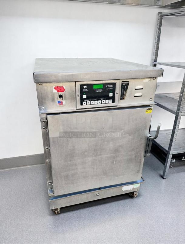 Winston CVap warming cabinet in stainless steel, featuring digital controls, in good condition with visible stickers and dials.