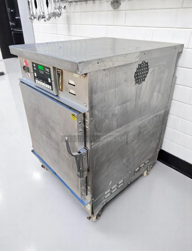 Commercial stainless steel oven on wheels with control panel, showing buttons and settings. Used condition.