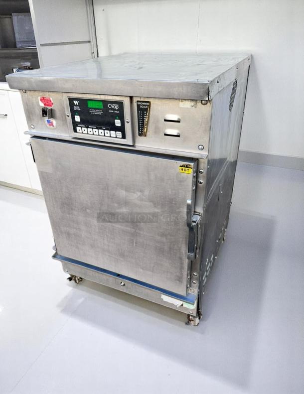 Commercial stainless steel CVap oven, model number visible, digital controls, browning scale, caution label indicating hot surface, signs of use.