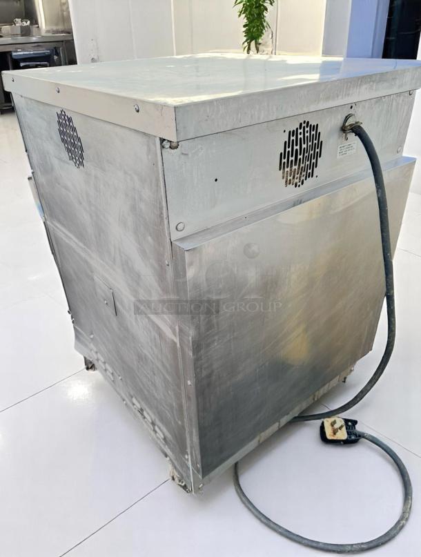 Commercial stainless steel equipment, used condition, vented side panel, power cord attached, suitable for industrial use.