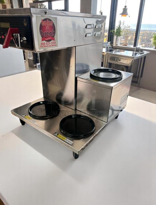 Stainless steel coffee brewer with two warmers, "Take a Break" service label, good condition, commercial use.