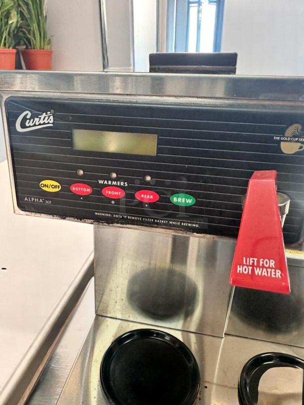 Curtis Alpha 3GT commercial coffee brewer. Features digital controls, hot water lever, and multiple warmer plates. Good condition.