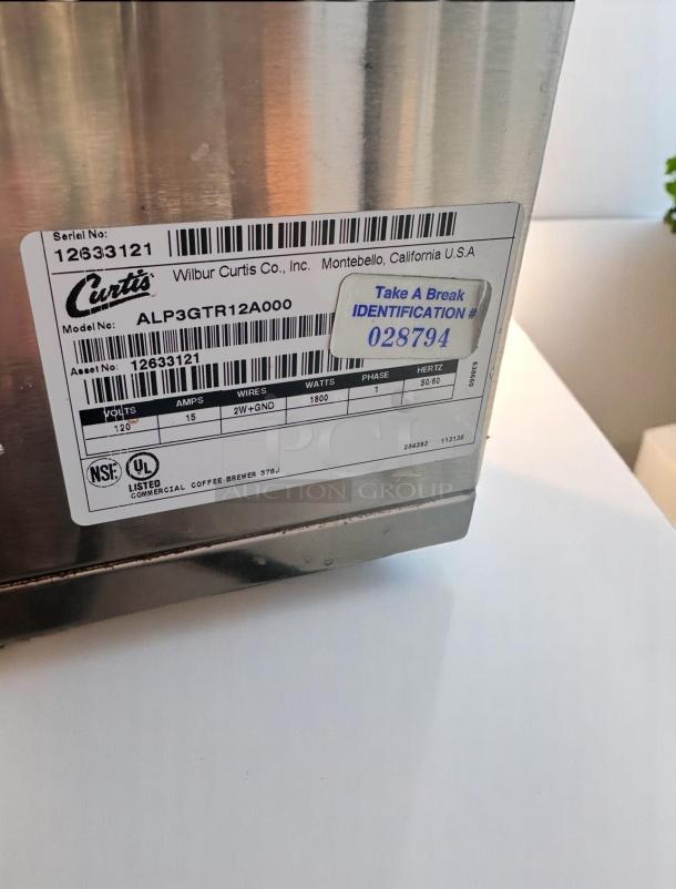 Wilbur Curtis coffee brewer, model ALP3GTR12A000, serial 12633121. Stainless finish, NSF and UL listed, 1800 watts.