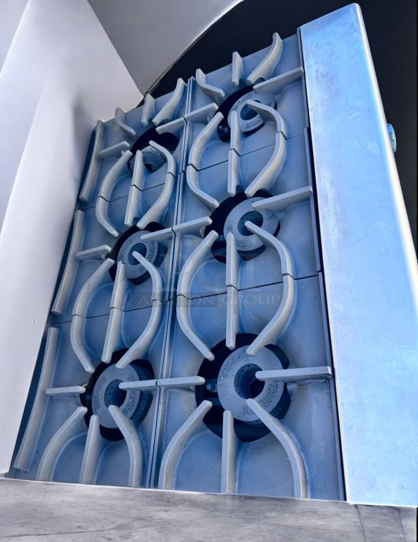 Commercial-grade stovetop with six burners, featuring heavy-duty cast iron grates, in excellent condition.