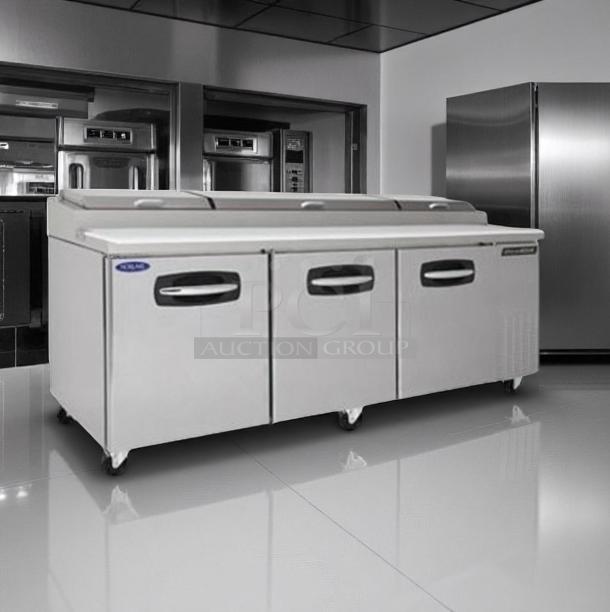 Stainless steel commercial refrigerator with three doors, on wheels. Excellent condition, brand label visible. Ideal for kitchen use.