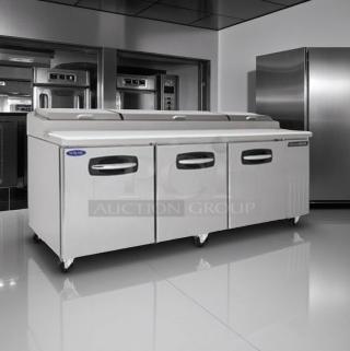Stainless steel commercial refrigerator with three doors, on wheels. Excellent condition, brand label visible. Ideal for kitchen use.