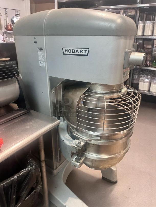 Hobart industrial mixer, stainless steel, used condition, visible wear, model label shows specifications, ideal for commercial kitchens.