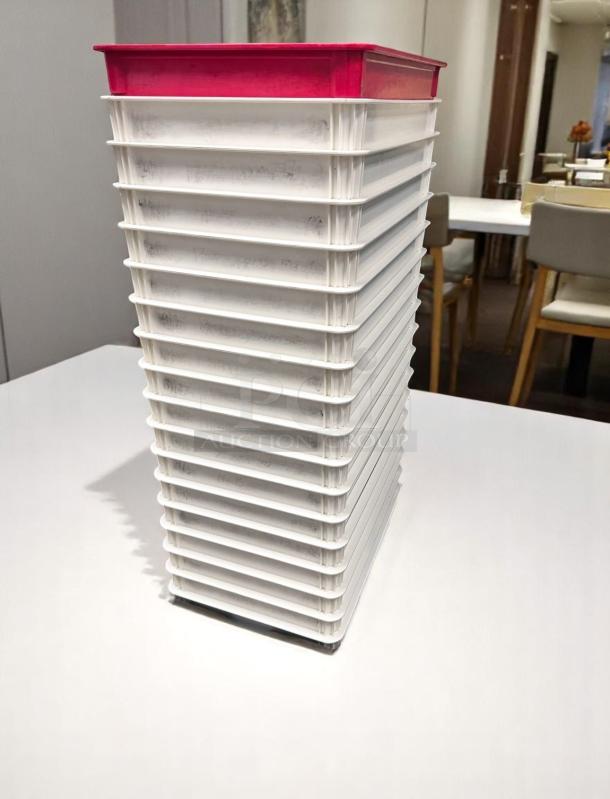 Stack of white plastic trays with red lid, in excellent condition. Suitable for organizing or food storage.