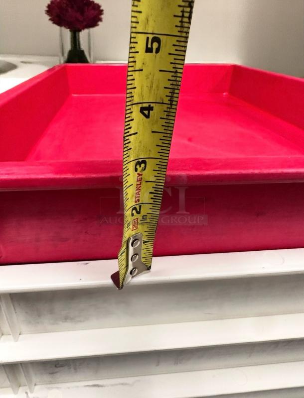 Red plastic tray with 5-inch depth shown by tape measure, clean condition, on white shelves.
