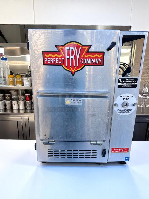 Perfect Fry Company commercial fryer, stainless steel, visible caution label for hot oil, emergency pull handle, good condition.