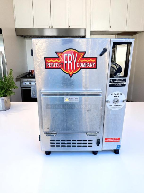 Perfect Fry Company countertop fryer, stainless steel, commercial-grade, moderate wear, caution labels for hot oil.