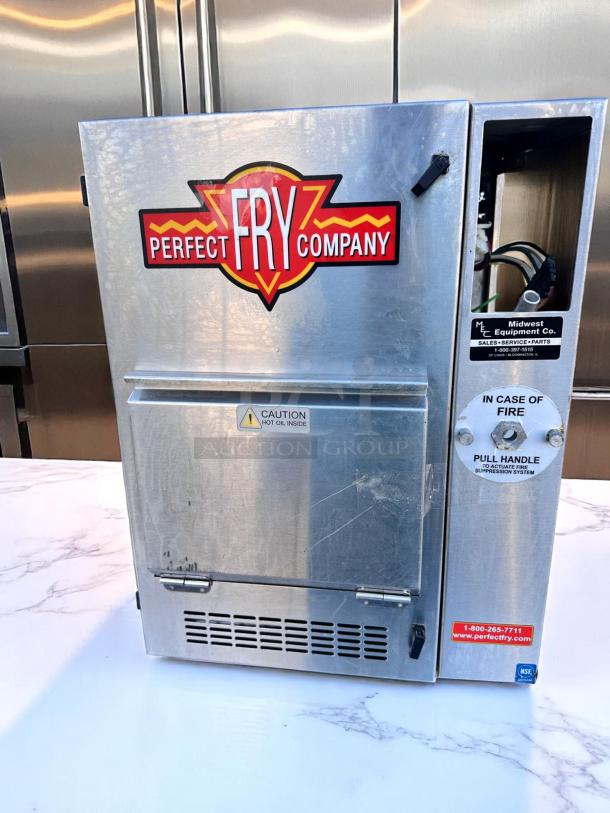 Perfect Fry commercial fryer, stainless steel, visible brand logo. Includes fire safety instructions and contact info label. Good condition.
