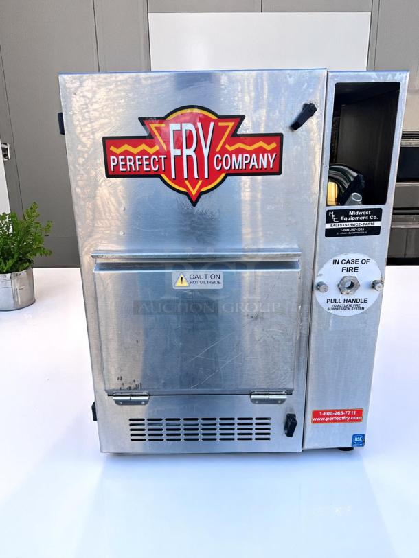 Perfect Fry Company commercial fryer, stainless steel, visible control panel, minor wear, safety labels, model number unclear.