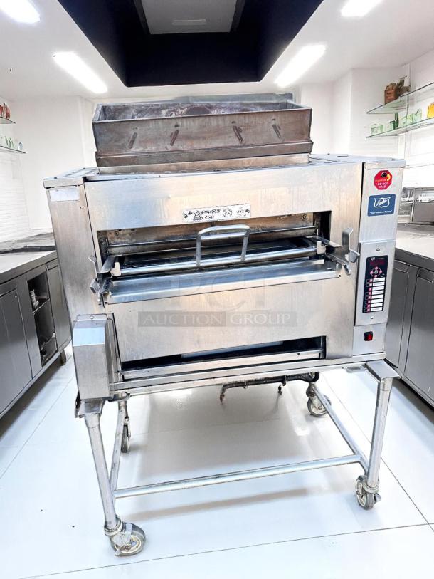 Commercial stainless steel oven on wheels, with visible control panel and warning labels, in good condition.