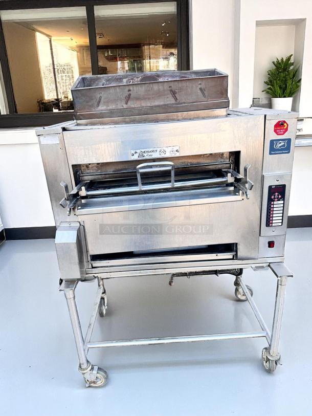 Commercial pizza oven with stainless steel finish, digital controls, and removable tray. Good condition, on wheeled stand.