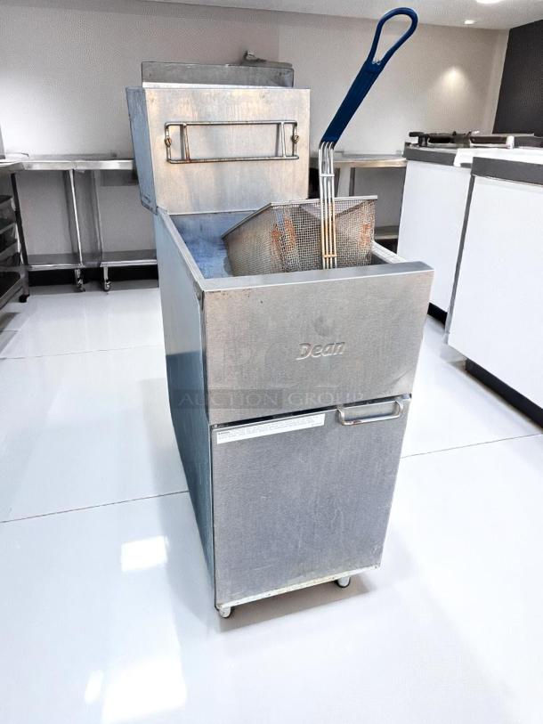Commercial Dean deep fryer in stainless steel, features large fry basket and blue handle. Clean and on casters for mobility.
