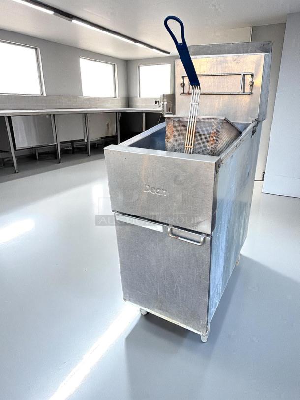 Dean commercial deep fryer with stainless steel body, basket, and blue handle. Used condition, on castors for mobility.