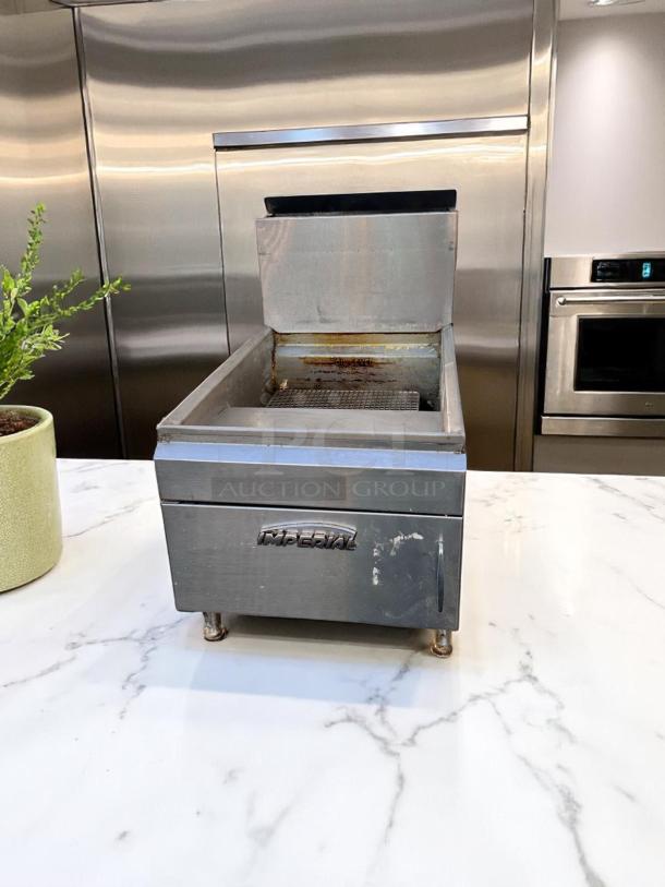 Stainless steel Imperial deep fryer, used condition, with visible wear and signs of use. Branding "Imperial" on front.