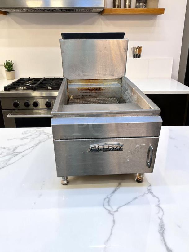 Imperial commercial countertop fryer in stainless steel. Features a mesh basket with visible wear, "Oil Level" label.